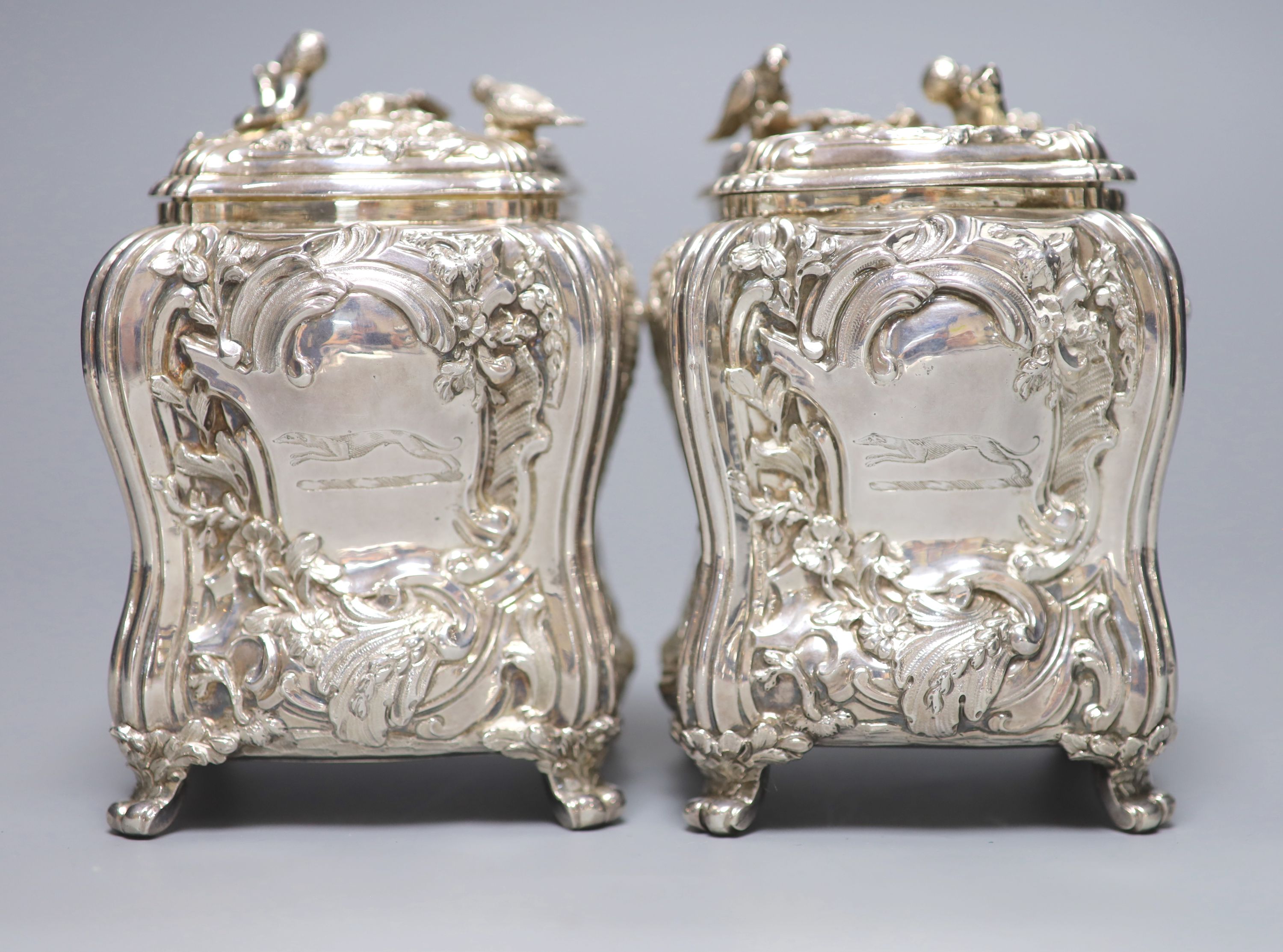 A good pair of George II embossed silver tea caddies and covers, by Elizabeth Godfrey, London, 1749/50, housed in a later 19th century pierced Canton ivory mounted caddy, with velvet interior